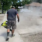  Urban Forest Landscaping employee clearing debris